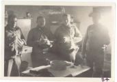 <h5>Combat</h5><p>Likely officers in a farmhouse kitchen. Identities unknown. Photo provided by the family of Elmore Willets. </p>