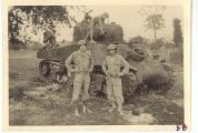 <h5>Combat</h5><p>Soldiers and child with wrecked Sherman tank (identities unknown). Photo provided by the family of Elmore Willets.</p>