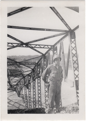 <h5>Downed Bridge</h5><p>Appears to be Clint Stillman in front of a destroyed bridge. Provided by the family of Ivo Schommer.</p>