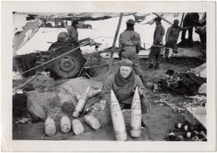 <h5>Clinton Stillman</h5><p>Clint Stillman with two 155mm shells. Photo provided by family of Ivo Schommer.</p>