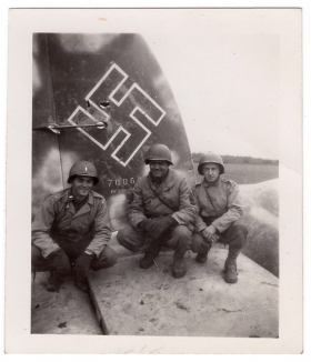 <h5>Nazi Plane</h5><p>Three soldiers pose on an enemy plane. Photo provided by family of Ivo Schommer.</p>