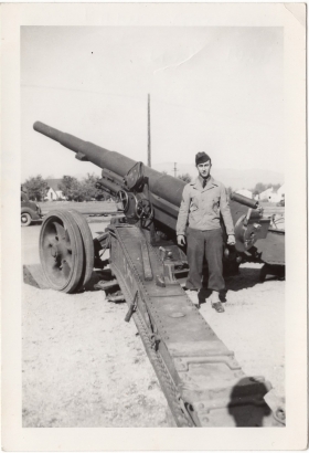 <h5>Ivo Schommer</h5><p>Ivo Schommer posing next to a cannon. Photo provided by family of Ivo Schommer.</p>
