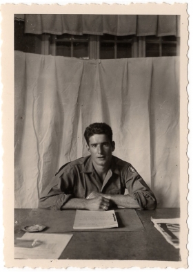 <h5>Soldier</h5><p>Unidentified soldier at desk. Photo provided by family of Ivo Schommer.</p>